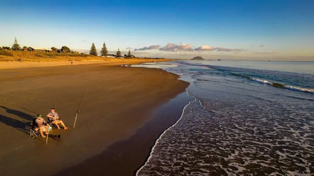 Two fishermen Papamoa beach scaled